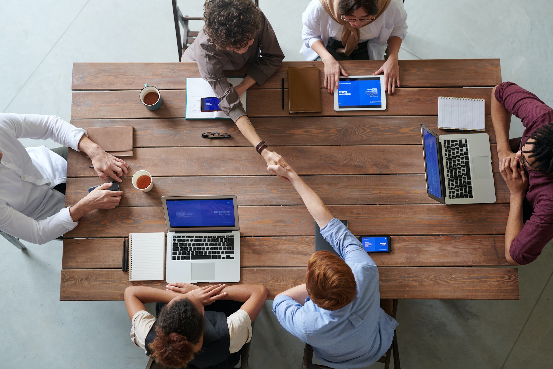 a team gathered around a table presentinfg to clients